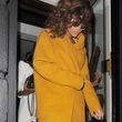 Rihanna con una chaqueta mostaza saliendo de un restaurante japonés